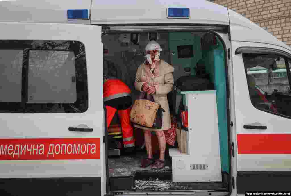 A woman injured in the attack in Kharkiv stands in an ambulance. Moscow repeatedly claims that only military targets are being attacked.