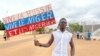 A supporter of Niger's ruling junta holds a placard in the colors of the Russian flag reading "Long Live Russia, Long Live Niger and Nigeriens" at the start of a protest called to fight for the country's freedom and push back against foreign interference in Niamey, Niger, on August 3, 2023.