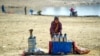 An Afghan tea vendor looks for customers along the shrunken Qargha Reservoir on the outskirts of Kabul on January 18.