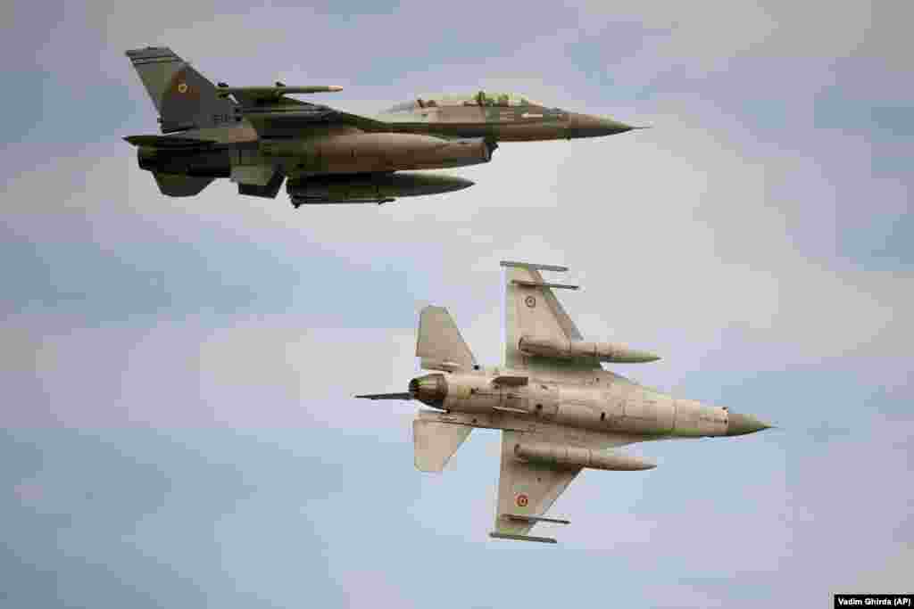 Romanian Air Force F-16 fighter aircraft fly over the inauguration of an F-16 training facility at the Baza 86 military air base, outside Fetesti, Romania, on November 13. The facility in southeast Romania aims to increase interoperability between NATO allies and better position the military alliance &ldquo;to face the complex challenges&rdquo; in Eastern Europe and the Black Sea region, Romania&#39;s Defense Ministry said.