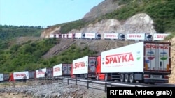 An Armenian convoy of trucks waits near an Azerbaijani checkpoint at the beginning of the Lachin Corridor on July 27. 
