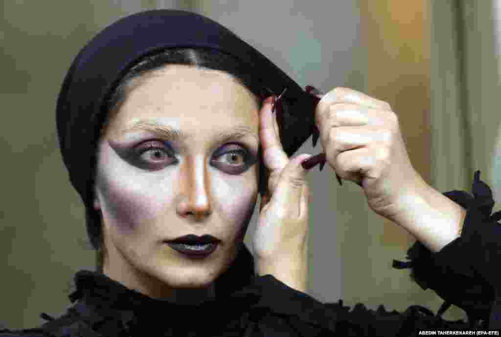 Iranian actor Mona Soufi gets her makeup done backstage before performing in the Haft-Khan Esfandiar musical theater production at the Vahdat Hall in Tehran.