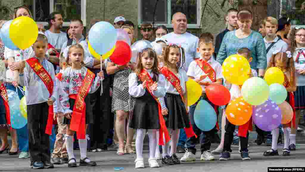 Moldovan children in traditional dress wait to enter the Tara Shevchenko school in Chisinau. Children across RFE/RL&#39;s region are welcoming the start of another year of learning.