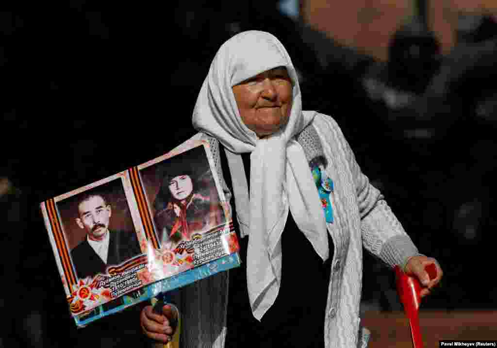 A woman carries portraits of Red Army soldiers during the celebrations of Victory Day, which marks the 78th anniversary of the victory over Nazi Germany in World War II, in Almaty, Kazakhstan, on May 9.