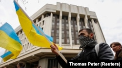 Проукраїнські протестувальники біля будівлі місцевого парламенту, Сімферополь, Крим, 8 березня 2014 року. «Це забута розкіш – побачити український прапор», – каже Джеміль, один і братів, які втекли з окупованого півострова