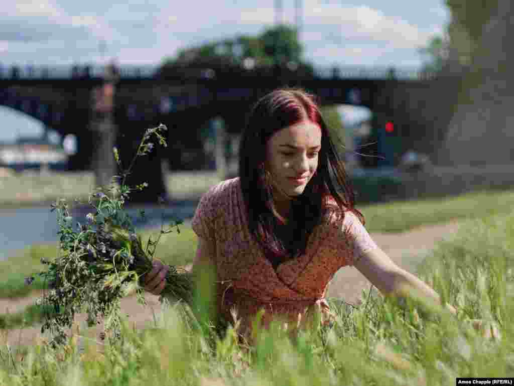 Maria from Kyiv gathers wildflowers on the bank of Prague&rsquo;s Vltava River on July 8 at an event organized to mark Ivan Kupala night. It is the third event of its kind to be held in Prague since Russia&#39;s 2022 invasion of Ukraine forced millions of Ukrainians to flee their country.&nbsp; &nbsp;