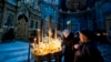 Believers light candles during the service for Orthodox Epiphany celebrations in the Nasterea Domnului Cathedral in Chisinau in January.