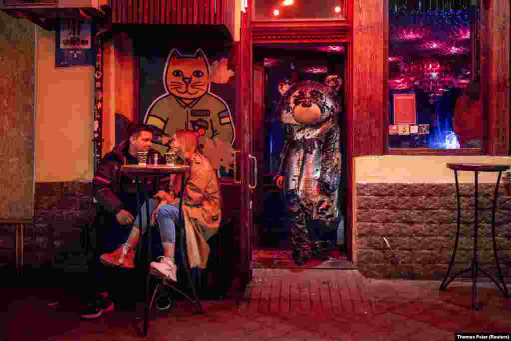 A man in a bear costume leaves a bar at night in central Odesa amid Russia&#39;s&nbsp;ongoing invasion of Ukraine.