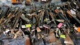 Serbia, unknown location -- Seized rifles and other weapons on display 