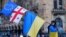 A demonstrator carries an EU flag with the Georgian and Ukrainian ones during a rally marking two years since Russia's full-scale invasion of Ukraine in Tbilisi on February 24.