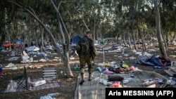 Un soldat israelian patrulează în apropiere de Kibbutzul Beeri, în sudul Israelului, la 12 octombrie 2023, în apropiere de locul unde 270 de persoane au fost ucise de militanți Hamas în timpul festivalului de muzică Supernova, la 7 octombrie.