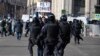 Police officers detain a man holding a placard reading "No to war" during a protest against Russia's full-scale invasion of Ukraine, in central Moscow on March 13, 2022.
