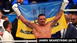 Oleksandr Usyk celebrates winning a fight in Wroclaw, Poland, in August 2023.