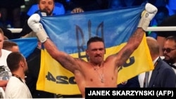 World boxing champion Oleksandr Usyk celebrates winning his fight against challenger Daniel Dubois from Great Britain in Wroclaw, Poland, on August 26. 