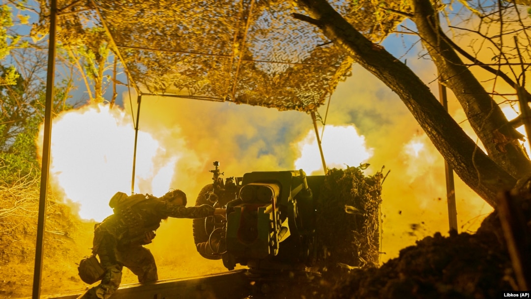 A Ukrainian soldier of the 10th Assault Brigade Edelweiss fires a D-30 cannon toward Russian positions at the front line, near Bakhmut, Donetsk region, Ukraine.