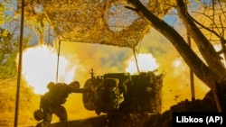 A Ukrainian soldier of the 10th Assault Brigade Edelweiss fires a D-30 cannon toward Russian positions at the front line, near Bakhmut, Donetsk region, Ukraine.