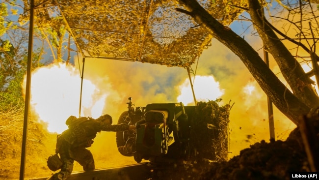 A Ukrainian soldier of the 10th Assault Brigade Edelweiss fires a D-30 cannon toward Russian positions at the front line, near Bakhmut, Donetsk region, Ukraine.