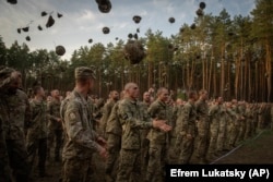 Newly recruited soldiers shout slogans as they celebrate the end of their training at a military base close to Kyiv in September last year.