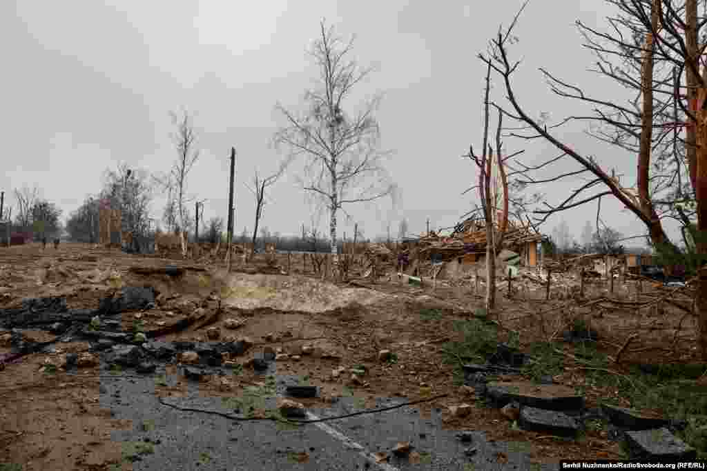 Imaginea 1: Un crater lăsat de o bombă și o casă distrusă în Teterivske. Imaginea 2: Același loc, după ce drumul satului a fost reparat, iar casa a fost demolată.