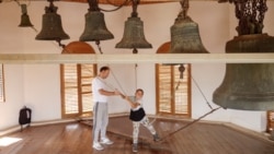 A boy being taught to ring church bells in the Lipovan village of Carcaliu on May 7