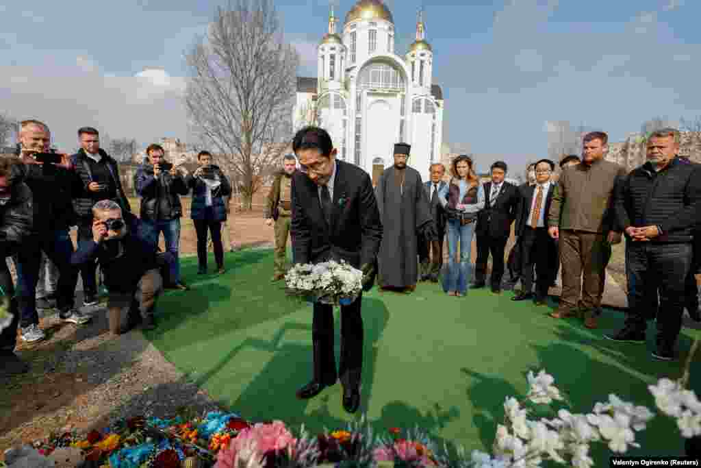 Japanese Prime Minister Fumio Kishida visits the site of a mass grave in the town of Bucha outside Kyiv on March 21.