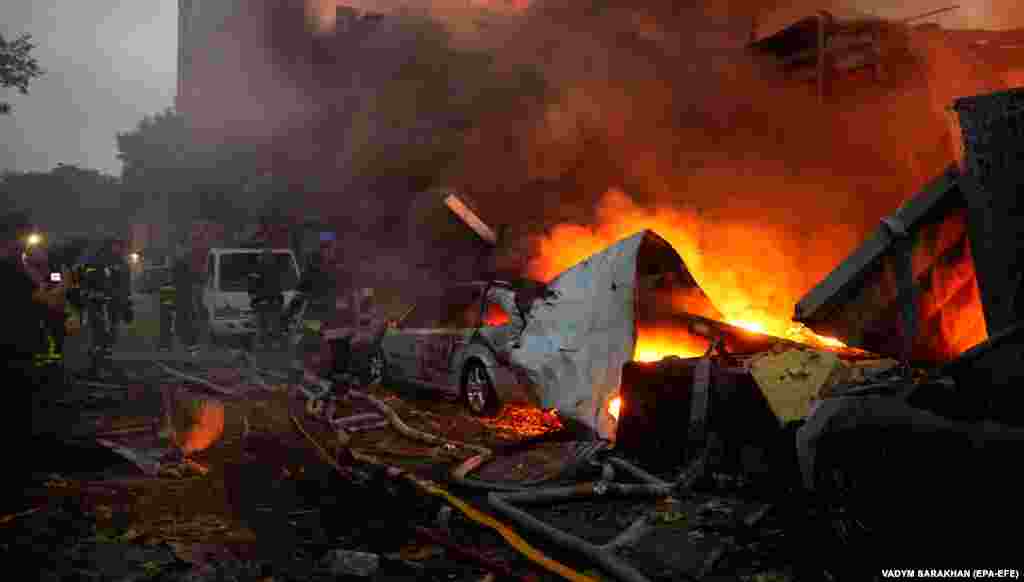 Firefighters work at the site of a Russian missile strike on the Ukrainian capital, Kyiv.&nbsp;