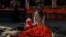 An Afghan street vendor arranges tomatoes for sale in Kabul. 
