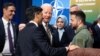 British Prime Minister Rishi Sunak (left) talks with Ukrainian President Volodymyr Zelenskiy (right) and U.S. President Joe Biden during a meeting of the NATO-Ukraine Council in Vilnius, on July 12.