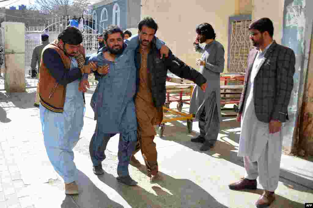 A bomb blast victim is helped to the hospital. The first attack happened in Pishin, a district in Balochistan Province near the Afghan border, local security official Naseebullah Kakar told RFE/RL&#39;s Radio Mashaal.