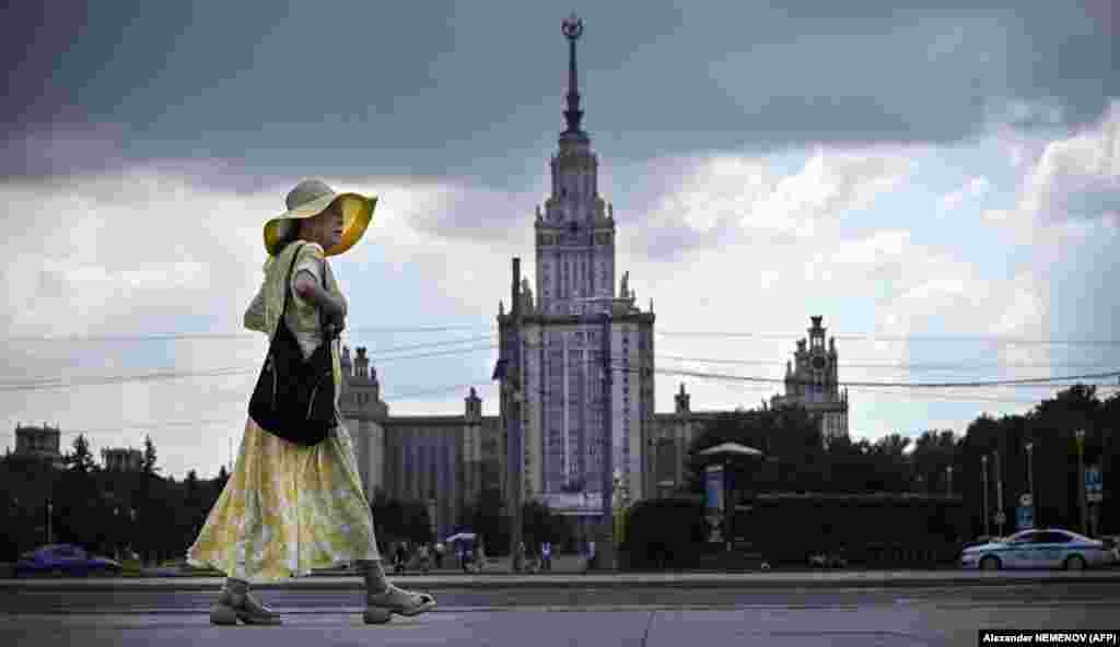 A Chinese tourist walks past Moscow State University in the Russian capital.