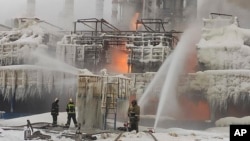 Russian firefighters attempt to extinguish a blaze at a gas terminal in the Baltic Sea port of Ust-Luga on January 21. 