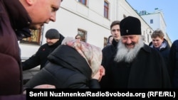 Believers kiss the hand of Metropolitan Pavlo of the Ukrainian Orthodox Church-Moscow Patriarchate on the territory of the Kyiv-Pechersk Lavra in Kyiv on March 30.