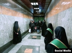 Hijab enforcers line up at the entrance to a subway station in Tehran.