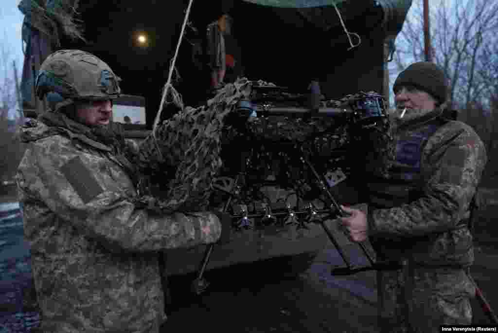 Ukrainian soldiers of the Achilles 92nd Brigade unload a Vampire combat drone near the front line city of Bakhmut on February 1. Nearly two years into Russia&rsquo;s full-scale invasion of Ukraine, the battlefield along the nearly 1,200-kilometer front has largely frozen, with both sides resorting to costly long-distance precision artillery, air-launched cruise missiles, and relatively inexpensive drones.