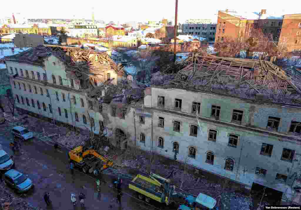 The sun rises above a residential building that was heavily damaged in Kharkiv. &nbsp;
