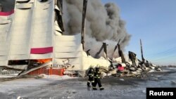 Firefighters work to put out the blaze at a warehouse of Wildberries online retailer in St. Petersburg, Russia, on January 13.