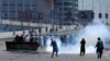 Supporters of former Prime Minister Imran Khan throw stones at police during a protest against his arrest in Peshawar, Pakistan, on May 10.