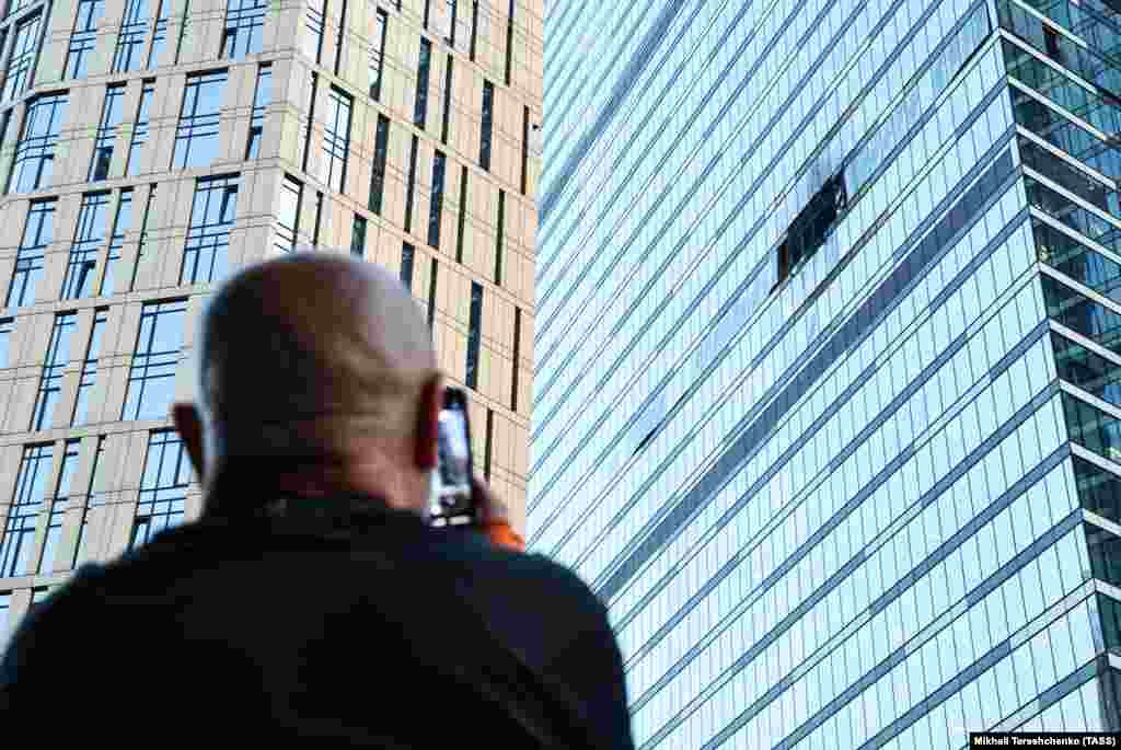 A man looks at the damage from a drone that exploded on impact with a skyscraper in Moscow&#39;s International Business Center on August 1.&nbsp;