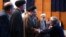 دست دادن غلامعلی حداد عادل با محمد خاتمی در مراسم سالگرد محمود دعایی، سرپرست پیشین مؤسسه اطلاعات