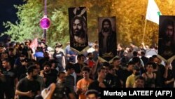 Iraqis rally on Tahrir Square near Baghdad's Green Zone on June 22, a day after an alleged burning of the Koran near the Iraqi Embassy in Copenhagen. 