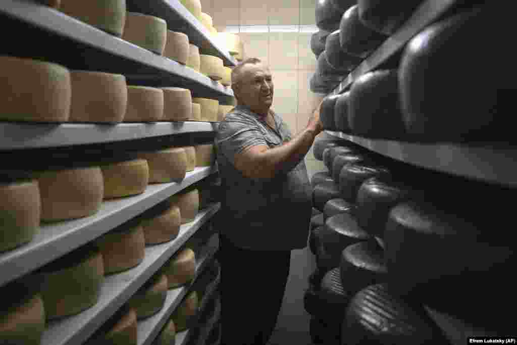 Viktor Tvysk inspects the storage of goat cheese. There are strategies such as bartering that Tsvyk has resorted to in order to keep the farm afloat. But he doesn&rsquo;t expect to make a profit -- breaking even is the best he can hope for.&nbsp;