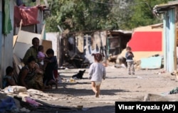 A child walks along a dirt road in the Cesmin Lug camp in 2010, a decade after the threat appeared to have been established.