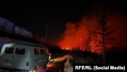 A fire glows in the distance after an apparent explosion on Russia's Baikal-Amur Main Line. 