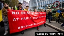 Protesters rally against allowing athletes from Russia and Belarus to participate in the 2024 Olympics in Paris in Lausanne, Switzerland, in March 2023.