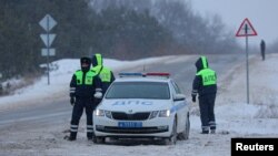 Руски сообраќајни полицајци блокираа пат во близина на местото на несреќата на воениот транспортен авион што се урна во регионот Белгород, Русија, на 24 јануари 2024 година.