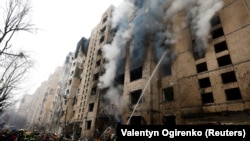 Firefighters in Kyiv work at a residential building that was heavily damaged during a Russian missile attack on January 2. 
