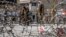 Taliban fighters stand guard at the explosion site near the Foreign Ministry in Kabul on March 27.