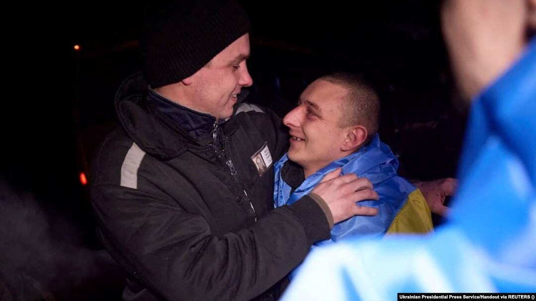Ukrainian prisoners of war react after a swap at an undisclosed location in Ukraine on February 8.