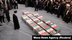 Iran's supreme leader, Ayatollah Ali Khamenei, looks at the coffins of members of the IRGC who were killed in the air strike in Damascus during a funeral ceremony in Tehran on April 4.