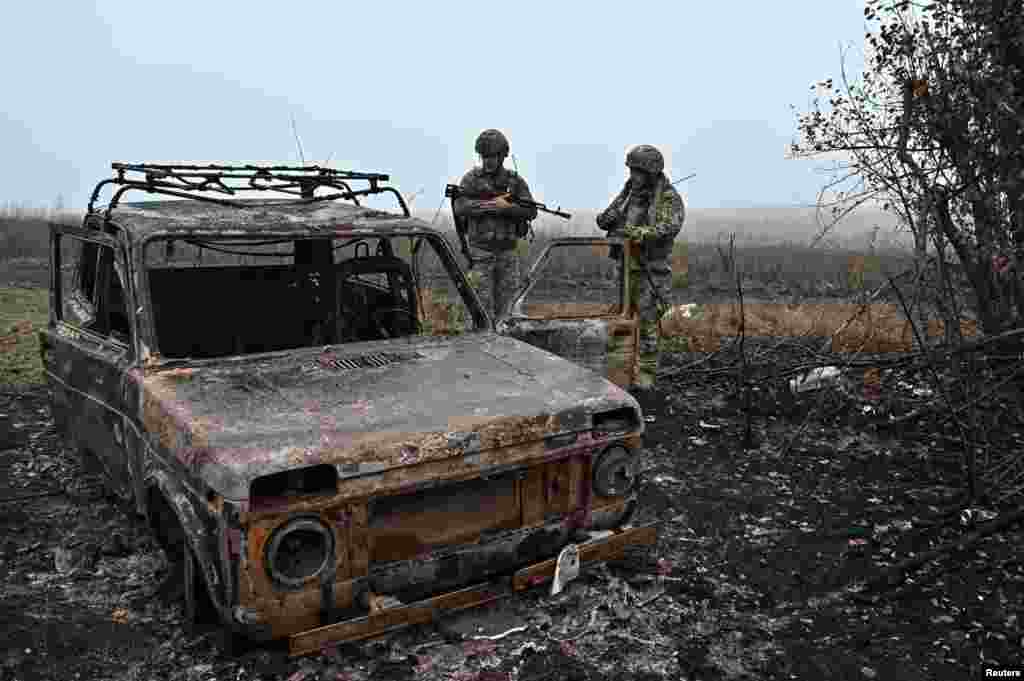 Ukrainian troops inspect a destroyed vehicle. Fighting has picked up in Zaporizhzhya, as Russian forces attempt to recapture Robotyne.